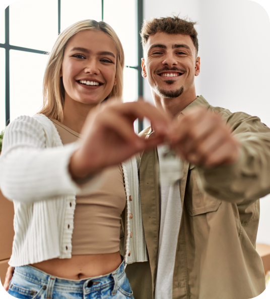 Smiling couple holding key to their new home traded in via Homage AI
